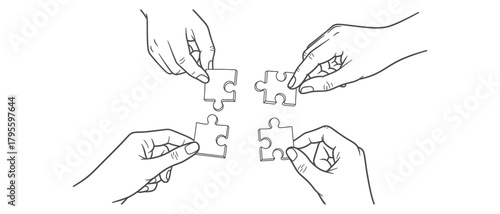 Hands assembling jigsaw puzzle pieces representing teamwork and problem solving concept