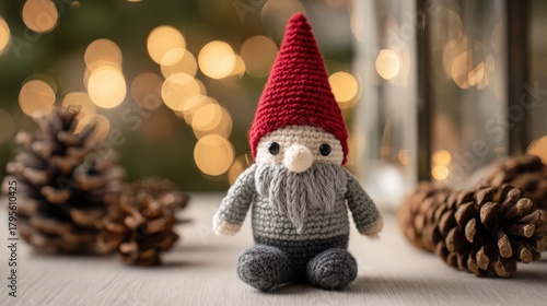 Cute hand crocheted amigurumi gnome toy decor on white table for holiday decoration