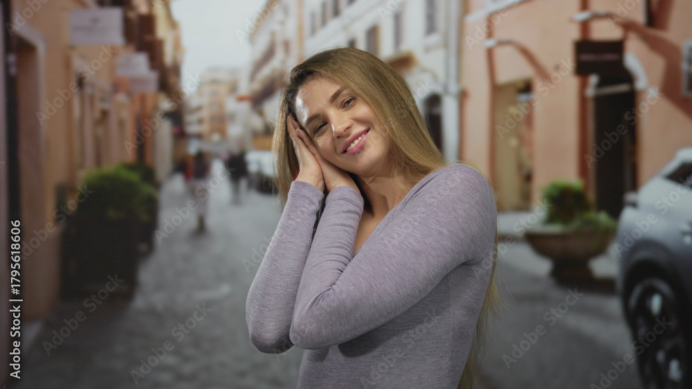 Fototapeta premium Woman smiling on a vibrant city street with blurred background, embodying a joyful outdoor urban scene with a serene atmosphere.