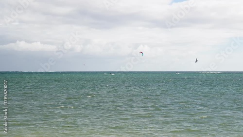 Kitesurfers Enjoying the Vast Expanse of the Ocean Under a Cloudy Sky, Capturing the Thrill of Watersports and Coastal Adventure, Symbolizing Adrenaline, Skill, and the Joy of the Sea