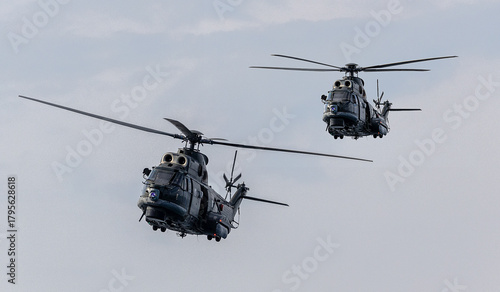 Valokuva A pair of attack helicopters flying in formation