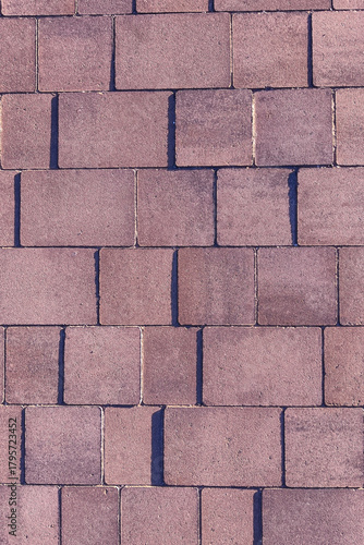  The wall is made of bricks and has a rough texture