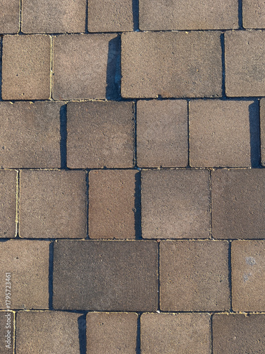  The wall is made of bricks and has a rough texture