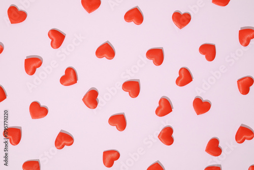 Seamless pattern of red hearts on a pink background. Playful and romantic design, perfect for Valentine’s Day, love-themed projects, greeting cards, and creative backgrounds.