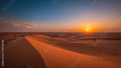 Fototapeta Naklejka Na Ścianę i Meble -  Desert landscape during sunset with sand dunes and a partly cloudy sky. Nature and landscape scenery. The desert environment at dusk.