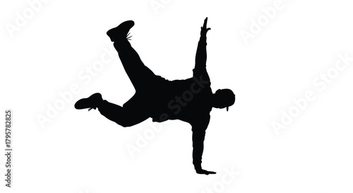 Silhouette dancer performing acrobatic move breakdancing
