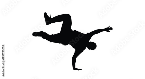 Silhouette of dancer performing acrobatic move breakdance