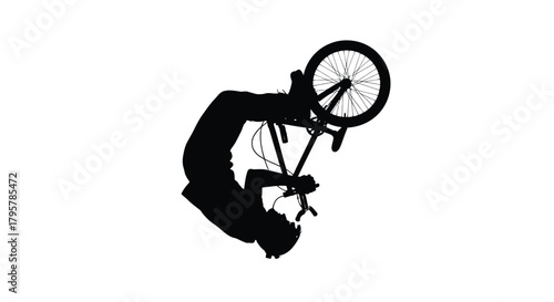 Black silhouette of cyclist performing aerial trick