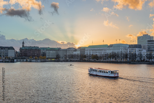 View of the Alster lake with an Alster steamer at golden hour