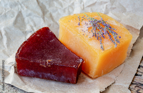 Two bars of handmade soap are placed on craft paper and decorated with dried flowers. The concept of natural cosmetics and body care in harmony with nature.