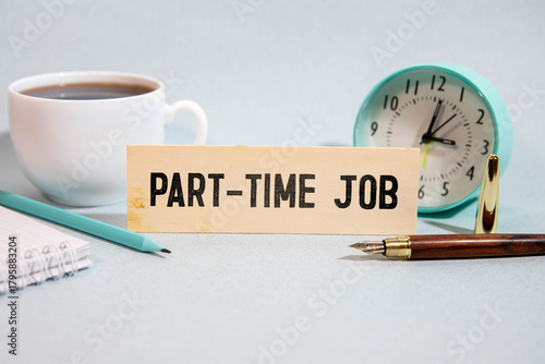PART-TIME JOB text on sticker on yellow notebook with chart and pen.