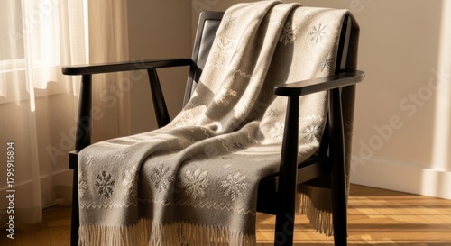Elegant Throw Blanket Drapped on a Stylish Wooden Armchair.