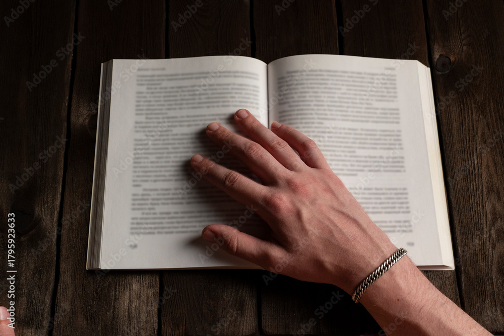 Naklejka premium Book and Hand with Silver Bracelet