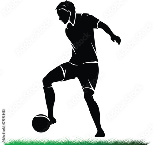 Silhouette of a soccer player dribbling the ball with grass