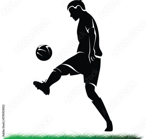 Silhouette of soccer player controlling ball on grass field