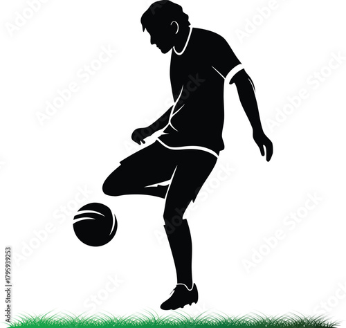 Silhouette of soccer player juggling ball on grass field