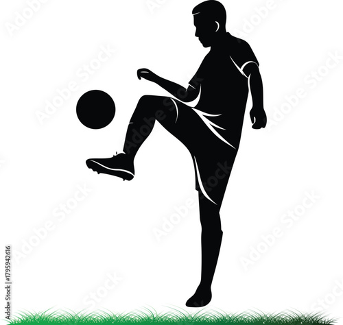 Soccer player silhouette practicing ball control on grass