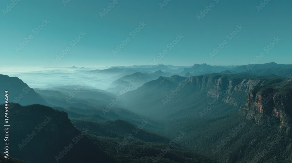 Fototapeta premium Breathtaking Landscape of Rolling Mountains Under Soft Blue Sky with Mist Shrouding Valleys and Thrilling Depths of Nature's Majestic Beauty