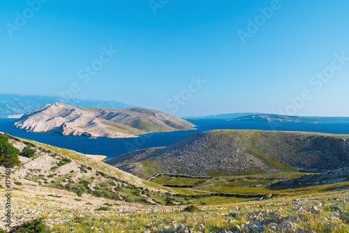 Serene landscape of krk island with clear blue sky and rolling hill. View of Prvic island, Croatia