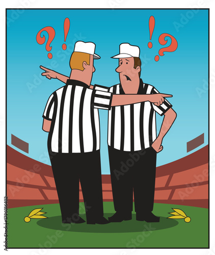 Two referees have a discussion after a penalty.