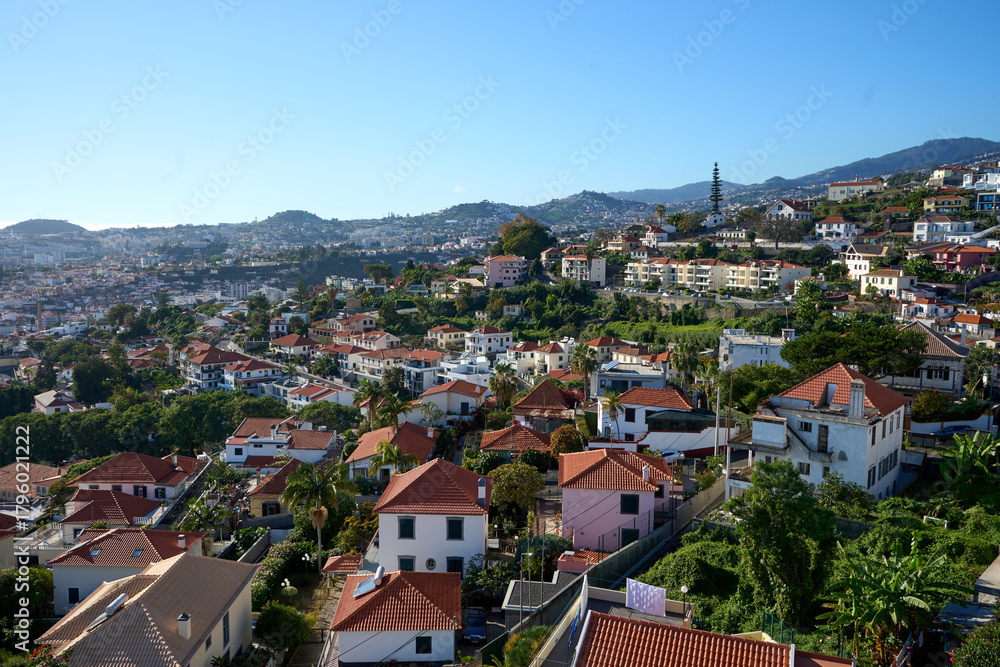 Fototapeta premium Aerial Car View Over Madeira Island, Distant Cityscape, Lush Mountains