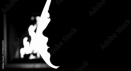 Dramatic Monochrome Silhouette of Woman's Profile with Bright Light & Blurred Flames
