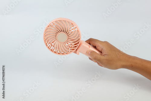 hand pressing power portable fan isolated on white background