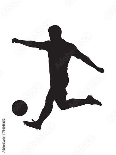Silhouette of a soccer player kicking the ball 