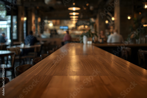 Empty wooden bar counter with defocused background of restaurant, bar or cafeteria
