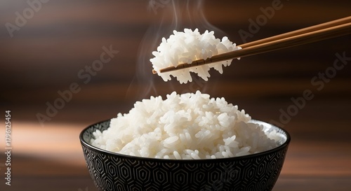 A close-up cinematic portrait photograph of steaming white rice served in a patterned bowl, captured with chopsticks lifting a portion