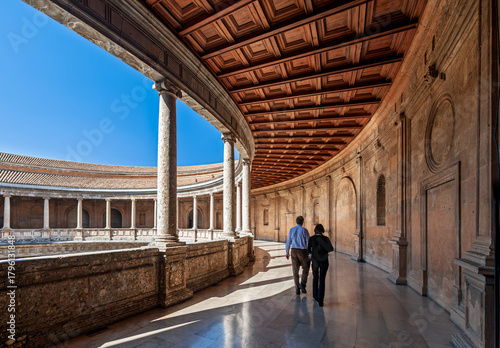 Couple enjoys a stroll in the Palace of Charles V in Granada