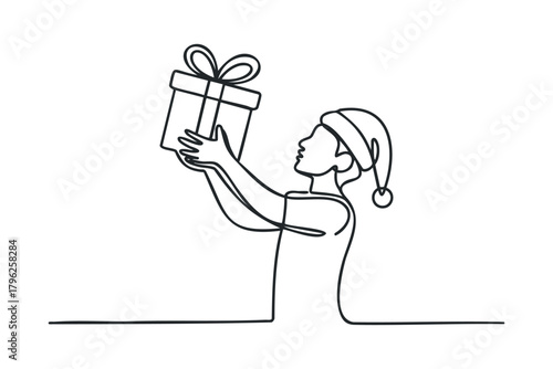 Person wearing Santa hat holding gift box