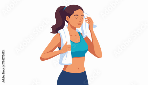 Young active woman wiping sweat from her face with a soft towel after an intense workout session, symbolizing post-exercise refreshment and dedication to a healthy fitness lifestyle