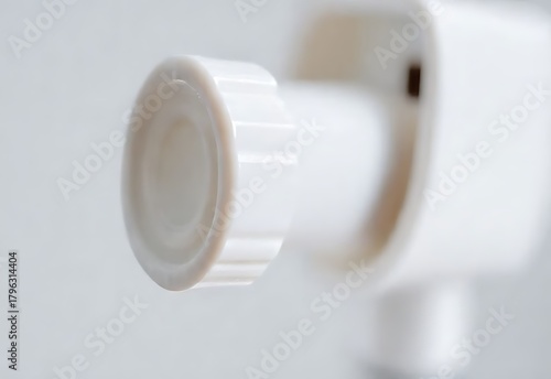 White plastic medicine bottle with pills isolated on white background