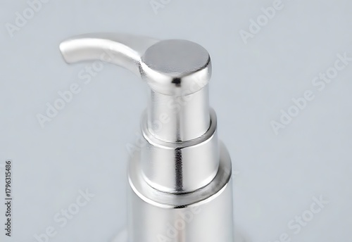 Flowing water from a chrome faucet with droplets in a clean bathroom setting