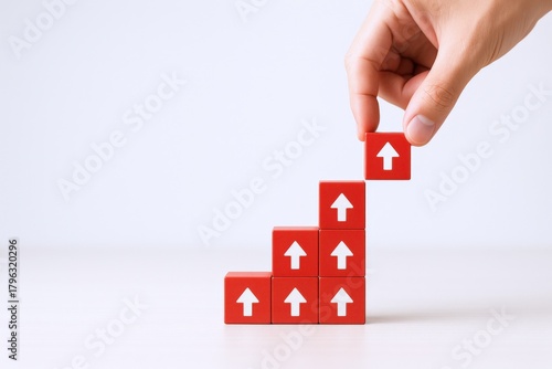 Ascending Red Block Staircase: Hand Placing Arrowed Cube for Growth and Progress, Isolated on White