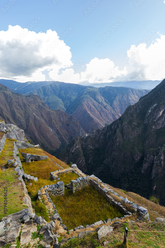 Fototapeta premium The mountains are covered in lush green vegetation and the sky is clear and blue