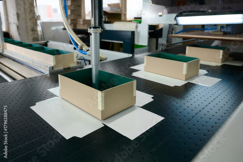 Innovative robotic technology enhances gluing process in cardboard box manufacturing at a modern production plant