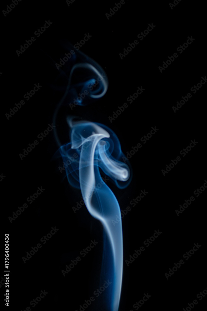 Obraz premium Blue hot curly steam smoke isolated on black background. Abstract background, design element, for overlay on pictures. Create mystical Halloween photos, for overlay on pictures