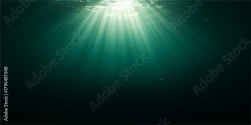 Bright blue sunlight rays burst through the dark ocean water, illuminating an underwater world background scene with rays