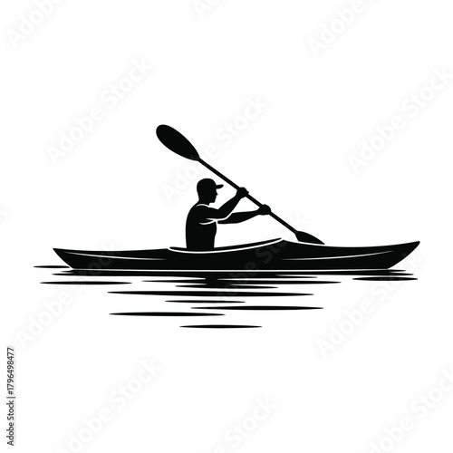 Silhouette of a kayaker paddling on water