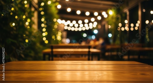 Wallpaper Mural Empty wooden table in foreground with blurry restaurant bokeh lights at night Torontodigital.ca