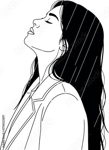 Young woman enjoying the rain with her face turned upwards