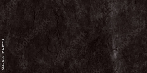 A dark textured surface resembling weathered stone or cracked earth occupies the frame displaying subtle tonal variations