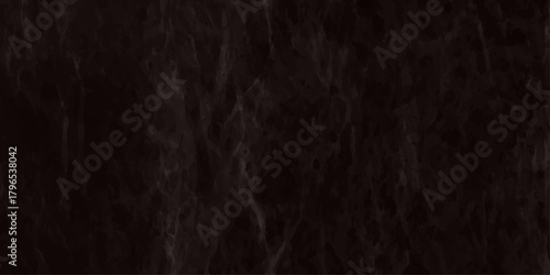 A close up view of dark flowing hair strands creates a textured monochromatic pattern with soft lighting and subtle variations