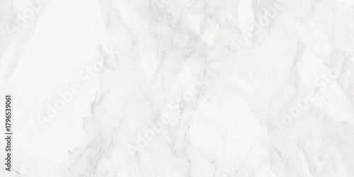 A detailed full frame view of a bright white marble surface with subtle gray veining patterns throughout the stone