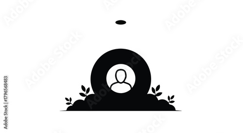 Solemn silhouette of a single person remembered at a grave site with foliage.