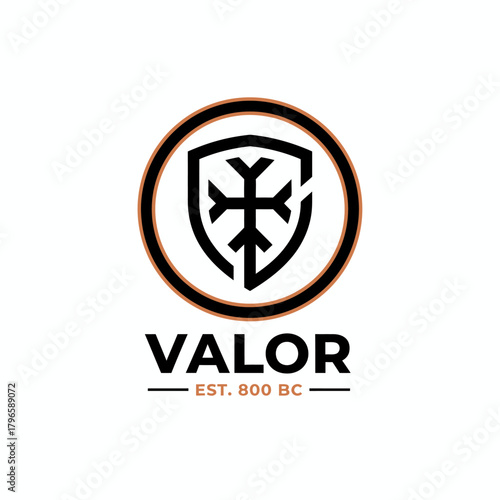 A circular emblem with a shield and cross design, the word below "VALOR" and an historical date