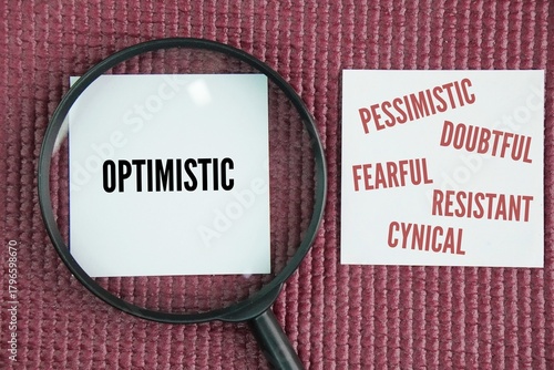 Magnifying glass and paper with the words Positive mindset optimistic and Negative mindset are pessimistic, doubtful, fearful, resistant, cynical