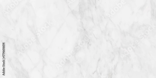 A detailed close up view of a white marble surface displaying subtle grey veining and texture